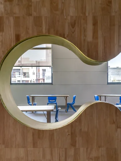 Great design is often found in the details. This playful, curved viewing window in a school environment is an example of how we craft moments of delight and curiosity, transforming a simple partition into an engaging architectural feature.