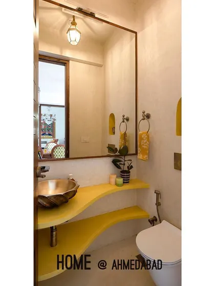 A pop of bright yellow on the custom-designed vanity adds a playful touch to this powder room. We believe even the smallest rooms should be creative and exciting, using color and form to make a statement.