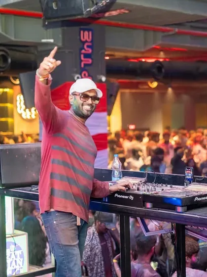 A great shot of me interacting with the Holi crowd from the DJ console. I'm always on the mic, making sure the energy stays high and everyone feels like part of the show.