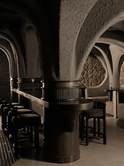 A view of the bar seating at Call Me Ten, integrated into the monolithic concrete structure. The design emphasizes a continuous, flowing geometry where walls, ceiling, and seating merge into a single architectural expression.