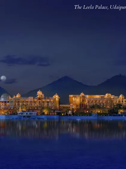 The Leela Palace, Udaipur, shimmering on the lake at night. A venue that is the very definition of royal splendor and a dream destination for a palace wedding.