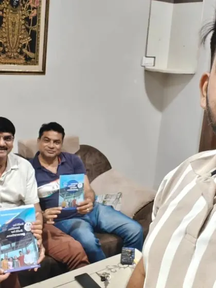Our team with two customers holding our solar guide.