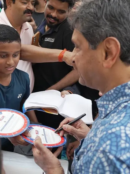 The legend himself, Prakash Padukone, signing autographs for a crowd of enthusiastic young players and fans. This is the inspirational value we bring to every tournament.