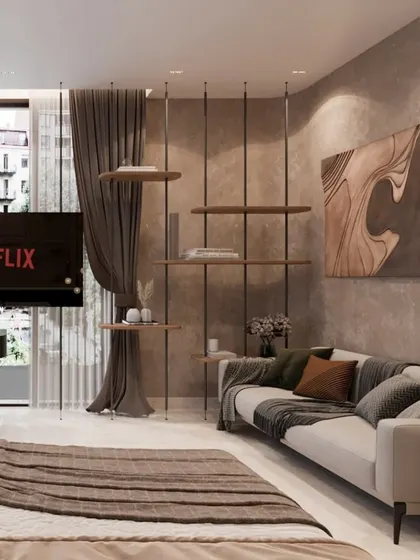 The lounge area within the master suite, featuring a sleek suspended shelving unit that acts as a subtle space divider. This corner is perfect for relaxation and watching TV, seamlessly integrated into the overall bedroom design.
