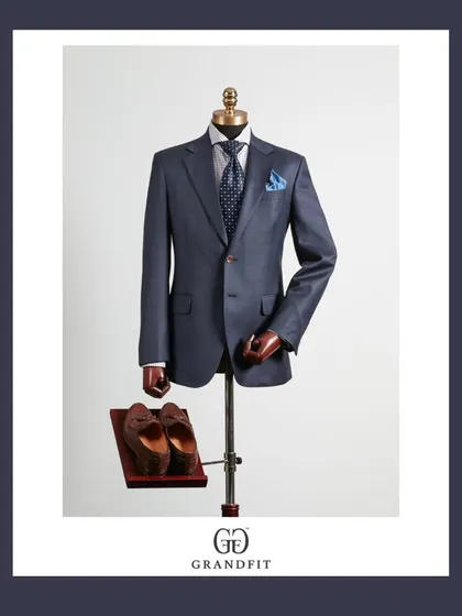 A slightly lighter blue suit offers a modern alternative for the boardroom. Paired with a patterned tie and pocket square, it demonstrates a confident approach to business attire.