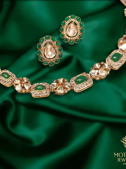 A beautiful necklace and earring set featuring Polki diamonds set with vibrant green enamel. The design is classic and elegant, perfect for festive occasions.
