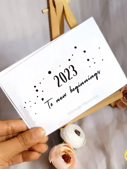 The cover card for the 2023 personalized desk calendar, reading "2023 To new beginnings," sets a hopeful tone for the year ahead.