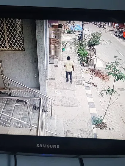 A view from the top of a staircase looking down at the building entrance and sidewalk.