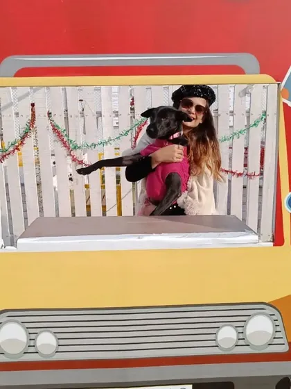 A guest and her dog strike a pose in the Christmas Carnival photo booth. Themed props and backdrops are a must for any festive event I plan.
