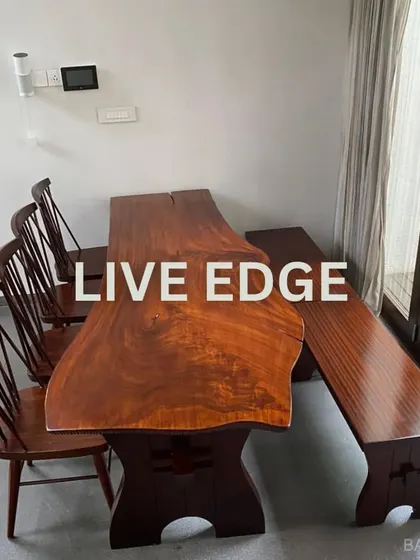 We love incorporating natural textures into our designs. This live-edge wooden dining table brings organic warmth and character to the dining space, proving that furniture can be both a functional piece and a work of art.