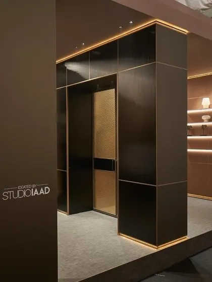 The entrance to our WALTZ 2024 exhibit for JB Glass at India Design Week. The design uses a sophisticated palette of dark tones, warm metals, and integrated lighting to create a sense of luxury and innovation from the very first glance.
