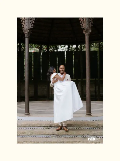 A joyful, romantic lift in front of the colonial bandstand. This classic "Hollywood" pose feels both timeless and spontaneous.