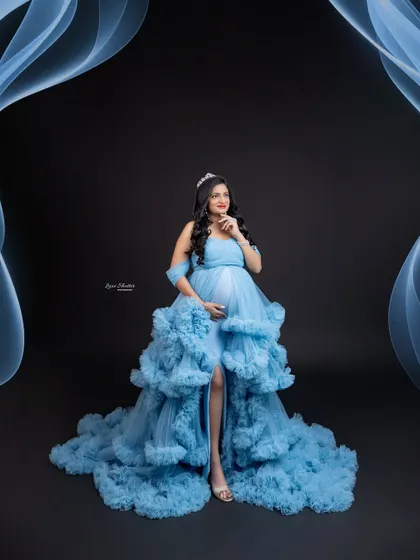 A creative edit with abstract blue smoke effects, adding a modern and artistic touch to this ruffled gown portrait.
