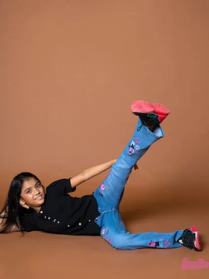 A playful pose on the floor, perfect for a kids' lookbook. It's a fun, unconventional shot that adds personality to the series.