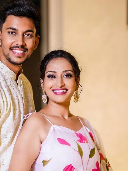 A classic and elegant portrait of a smiling couple, captured with soft lighting.