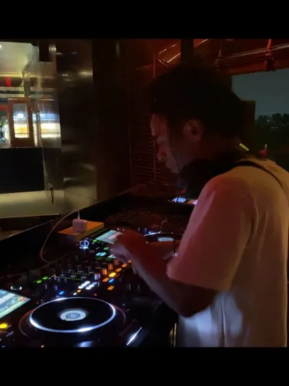A side profile shot while I'm in the middle of a mix. Every set is a performance, and I bring my full energy to the booth.