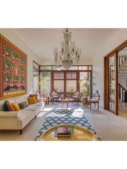 The living room of Casa Aum is a cooperation of design, art, and functionality. A large, traditional Indian tapestry serves as a stunning focal point, reflecting the client's love for cultural art.
