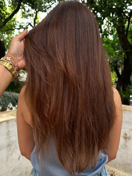 A shot of Amyra Dastur's hair from the back, showing off the subtle balayage highlights and the healthy shine.