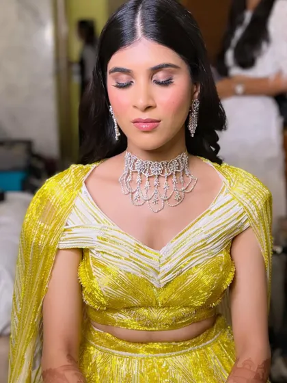 A close-up of this sangeet look, showing the soft smokey eye and perfectly blushed cheeks. The glossy lips add a final touch of glamour.