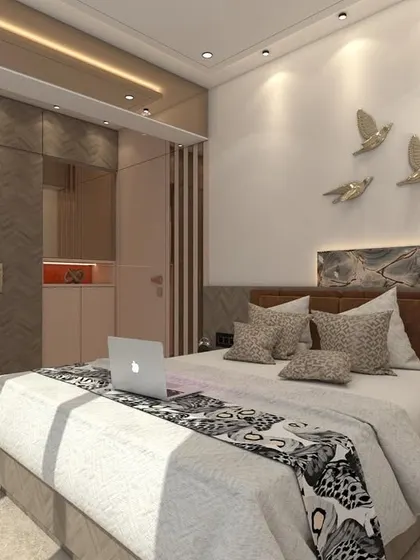 A wider view of the Bhayandar master bedroom, showing the complete layout with the bed, wardrobe, and study area. The design is cohesive and makes efficient use of the available space.
