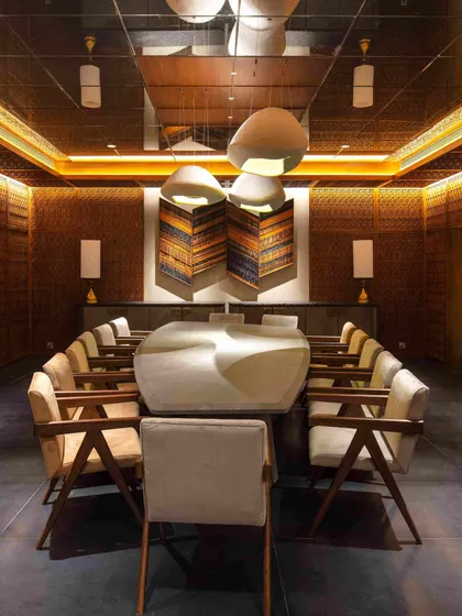 Another angle of the dining room, emphasizing the warm, glowing atmosphere created by the combination of intricate woodwork, soft lighting, and a rich material palette.