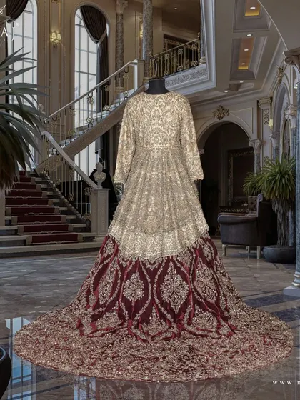 A full view of the gold double-layered peplum top and reddish maroon tail lehenga, a masterpiece of cultural elegance.