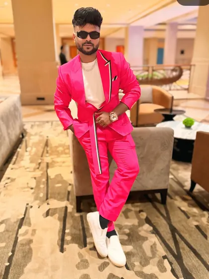 "Expertly hosting, impeccably dressed." A bright pink suit for a modern, chic event.