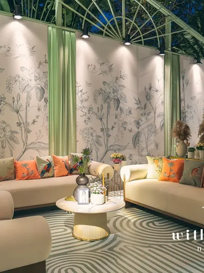 The lounge area of 'The Conservatory' at night, with the custom wallpaper beautifully illuminated.
