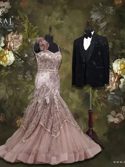 A study in fineness and charm. The groom's elegant black velvet tuxedo, sparkling with appliques, is the perfect match for the bride's intricately patterned coffee brown mermaid gown.