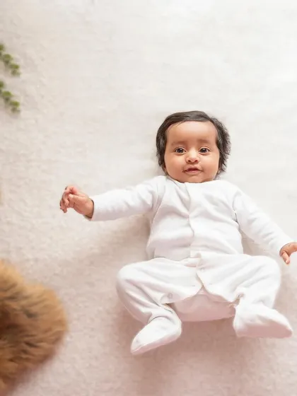 For the love of whites. This simple overhead shot of a baby in a white onesie on a white rug is a classic for a reason. It's clean, sweet, and absolutely timeless.