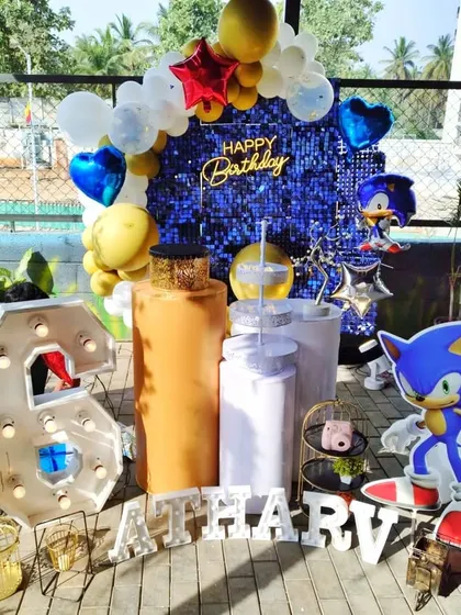 A Sonic the Hedgehog themed party with a blue sequin backdrop and character cutouts, perfect for a 6th birthday.