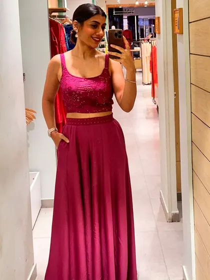 Trying on a stunning magenta co-ord set with palazzo pants and a crop top. This is a great example of a contemporary festive outfit that is both stylish and comfortable.