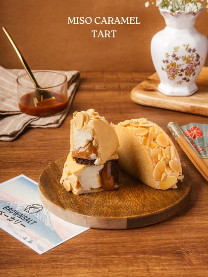 Our Miso Caramel Tart, a standout from The Japan Edit, offering a unique blend of sweet and savory flavors with a crunchy almond topping.