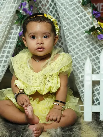 A close-up from a tent-themed photoshoot. The soft lighting and gentle colors are perfect for capturing the sweet expressions of a toddler.