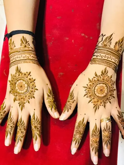 A clean and elegant mandala design for both hands. The pattern is centered on the back of the palm with simple, matching designs on the fingers and wrists.
