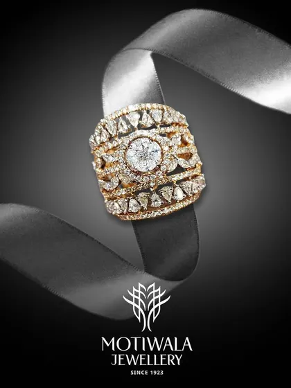 A wide band ring with intricate openwork and a central solitaire, wrapped around a ribbon. This image beautifully captures the idea of a ring as a precious gift.