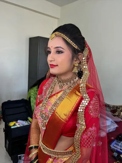 A side view of Sanjana's look, showing the neat bridal updo and the delicate veil setting. Every detail is carefully planned.