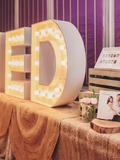 Large marquee letters spelling out the birthday boy's name, "VED," created a bright and personalized focal point for the party decor.