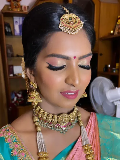 For her temple wedding, this pretty bride wanted a fresh and subtle makeup look. I used soft pink and gold eyeshadow with a sharp winged liner and a matching lip color to enhance her features beautifully.