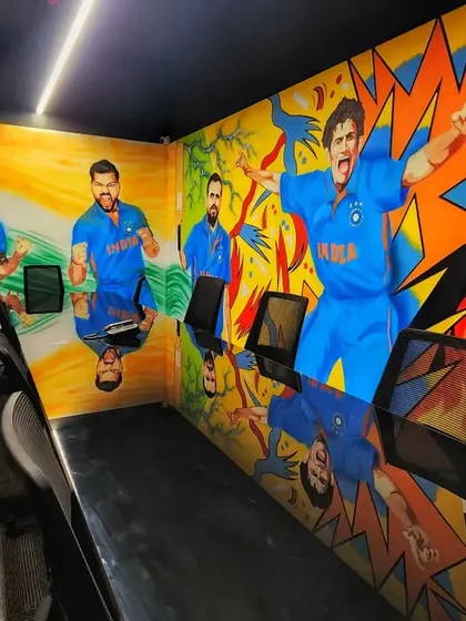 A view from inside the conference room, with the vibrant pop art mural of cricket stars reflected on the glossy table.