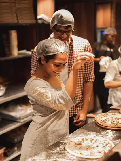 Another shot of our Parm Queen, smiling and enjoying her work in our open kitchen.