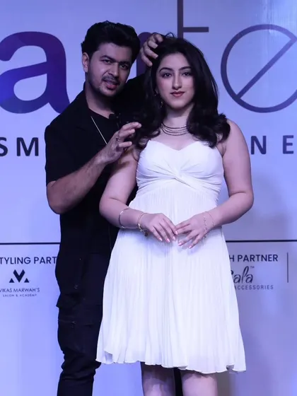 Posing with a model after a live demonstration at the Beautech Cosmetic & Salon Expo.