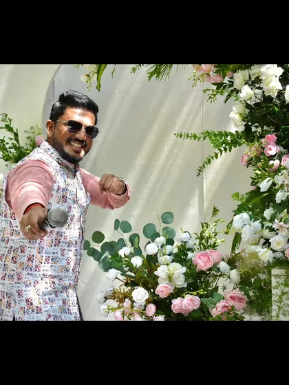 A fun, pointing pose amidst the beautiful Haldi decor.