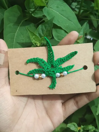 A custom-made marijuana leaf rakhi for a client with a specific request. I'm always open to creating unique and personalized designs.