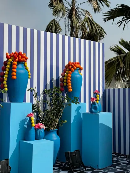 From concept to execution in just 42 hours. This St. Tropez inspired decor in Ahmedabad involved transforming a bungalow with custom-painted walls, fruit-based installations, and unique props, all on a tight deadline.