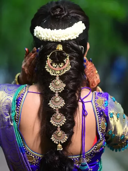 A beautiful hair accessory with chandbali-style hangings, perfect for adorning a bridal braid.