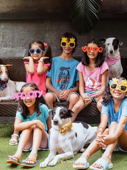 Five kids, three dogs, and one very happy photographer! This fun, chaotic, and colorful group shot with silly glasses perfectly captures the energy of a big, happy pack.
