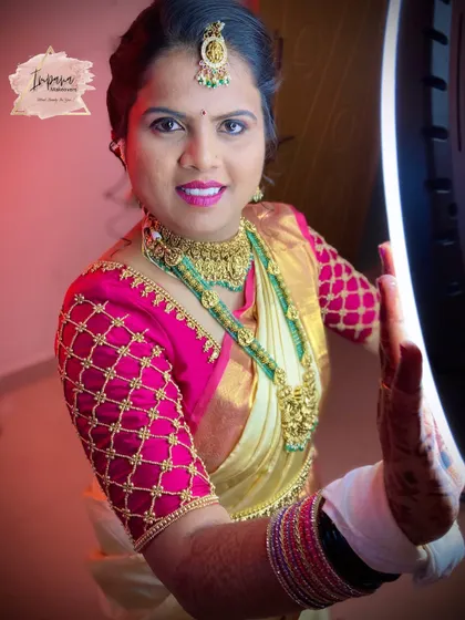 A close-up of this bride's radiant smile, ready for her wedding rituals. The makeup is designed to be bright and photogenic, enhancing her features while still looking natural.