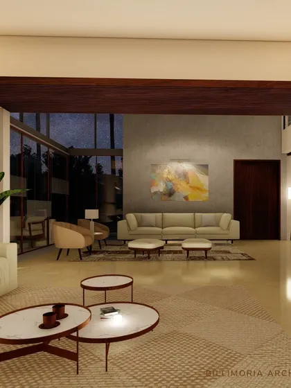 This living room is designed with a double-height ceiling and expansive windows, creating a grand yet inviting atmosphere. The neutral furniture and warm wood tones are complemented by soft, ambient lighting.