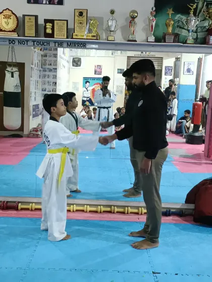 A handshake for a new yellow belt.